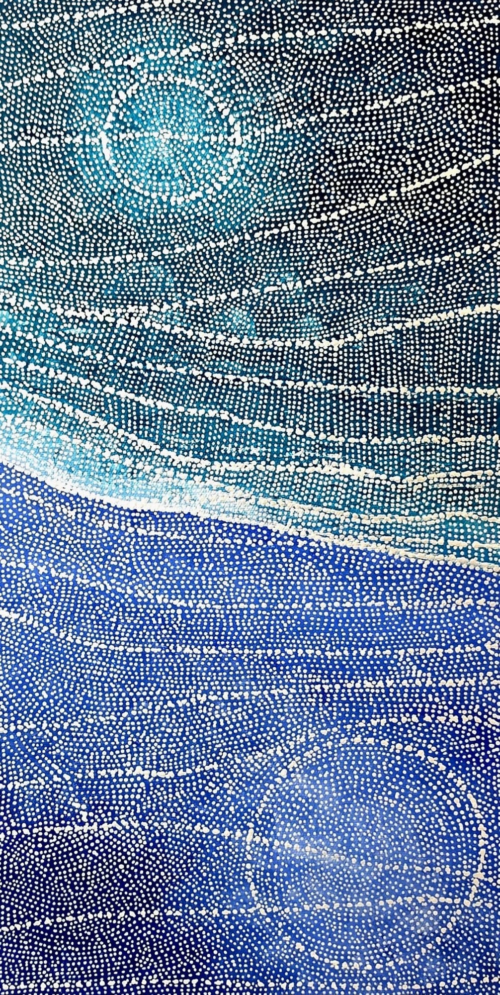 Aerial-style dot painting in deep blue and teal, with a luminous circular waterhole below and a glowing celestial body above, divided by horizontal bands of dotted current.