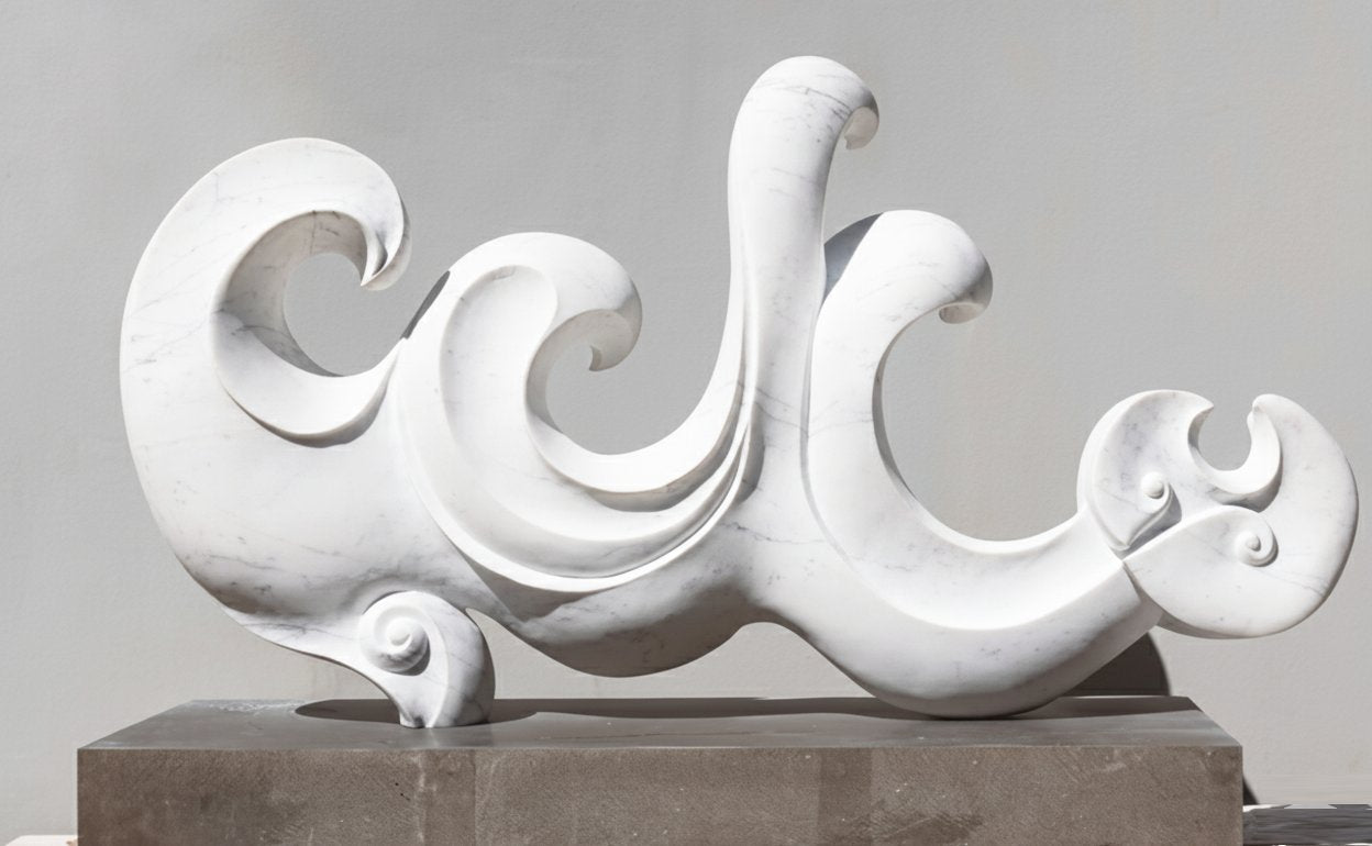 A large white marble sculpture of curling wave-like forms suggesting a resting lion, mounted on a low grey plinth.
